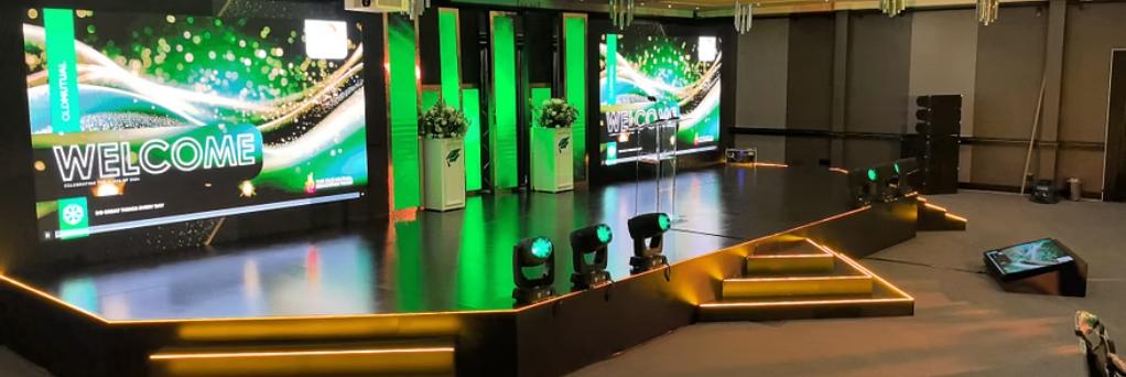 Corporate portfolio milestone featuring Old Mutual branding with elegant green event staging and professional setup