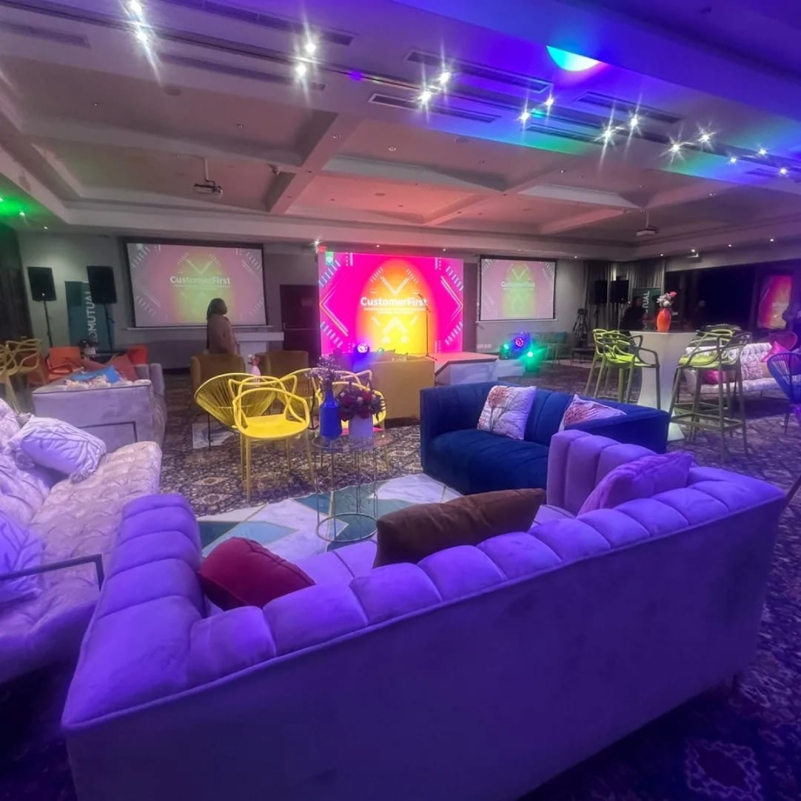 Brand activation lounge with branded screens and staging